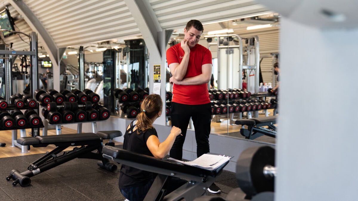Personal trainer and client in a gym location